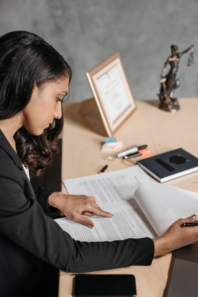 pexels photo 8111812 Businesswoman in an office reviewing documents with concentration and focus.
